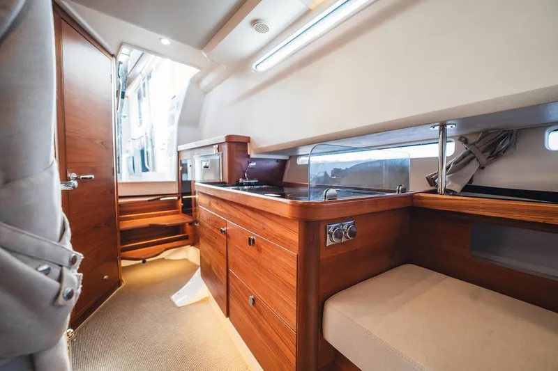Slide: The Image of Luxurious interior of 2023 Nimbus Commuter 11 boat with wooden cabinetry and seating. - 30
