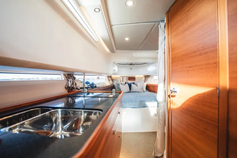 Slide: The Image of Luxurious interior of 2023 Nimbus Commuter 11 yacht with modern kitchen and cozy bedroom. - 33