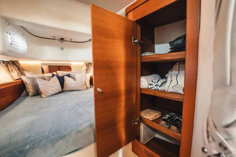 Slide: The Image of Cozy cabin interior of 2023 Nimbus Commuter 11 with bed and wooden storage. - 34