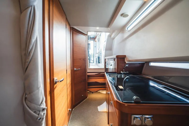 Slide: The Image of Luxurious interior of 2023 Nimbus Commuter 11 yacht with modern kitchen and wooden finishes. - 35