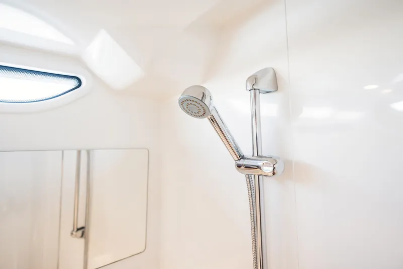 Slide: The Image of Shower area in 2023 Nimbus Commuter 11 boat, featuring sleek chrome fixtures. - 38