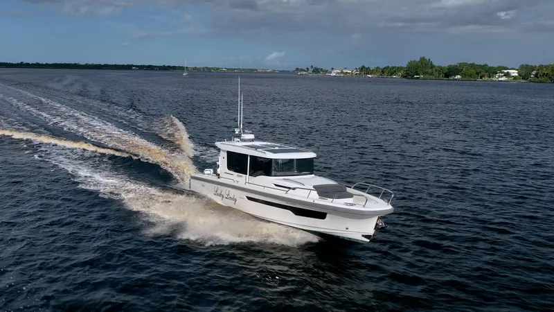 Slide: The Image of 2023 Nimbus Commuter 11 boat cruising on open water. - 41