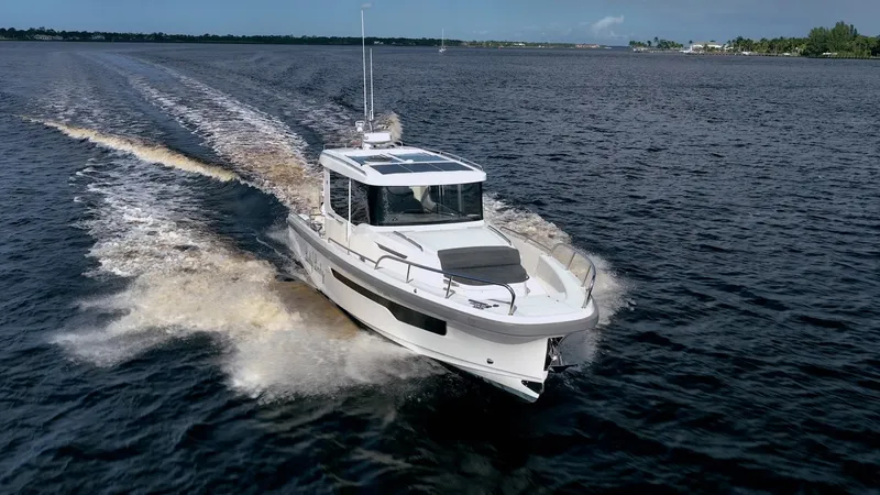 Slide: The Image of 2023 Nimbus Commuter 11 boat cruising on open water. - 42