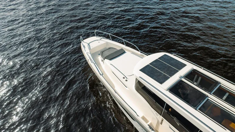 Slide: The Image of 2023 Nimbus Commuter 11 boat cruising on open water. - 44