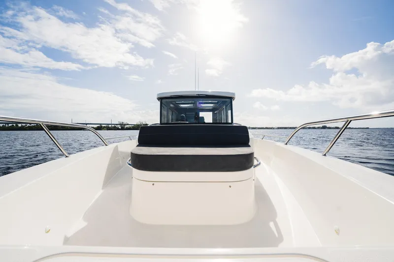 Slide: The Image of 2023 Nimbus Commuter 11 boat on open water under sunny sky. - 45