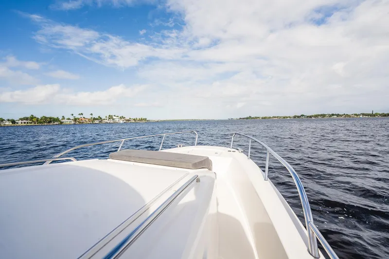 Slide: The Image of Nimbus Commuter 11 boat cruising on open water under a blue sky, 2023 model. - 47