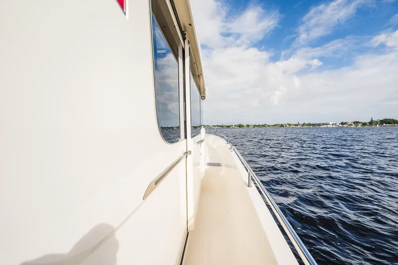 Slide: The Image of 2023 Nimbus Commuter 11 cruising on a sunny day over calm waters. - 48