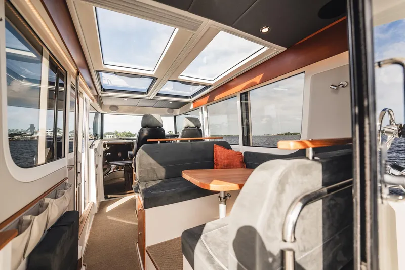 Slide: The Image of Luxurious interior of 2023 Nimbus Commuter 11 boat with panoramic windows and skylights. - 9