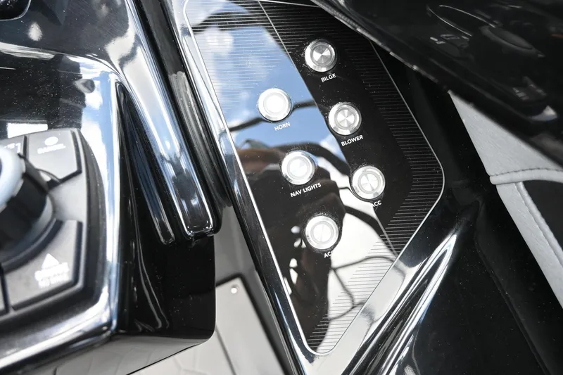 Slide: The Image of Control panel of 2021 Yamaha Boats 255XD with various buttons and switches. - 10