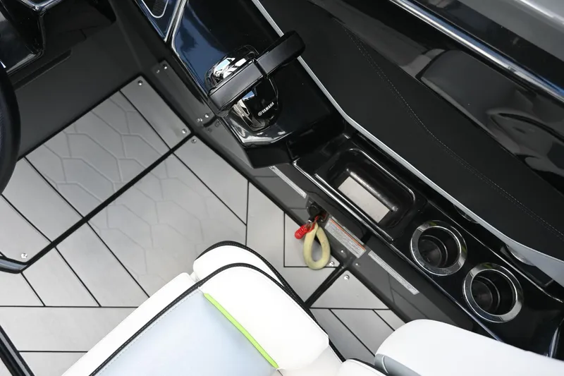 Slide: The Image of 2021 Yamaha Boats 255XD interior, featuring sleek controls and modern seating. - 11