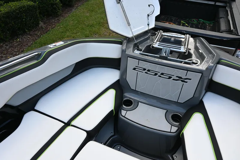 Slide: The Image of Interior of 2021 Yamaha Boats 255XD, featuring seating and storage area. - 13