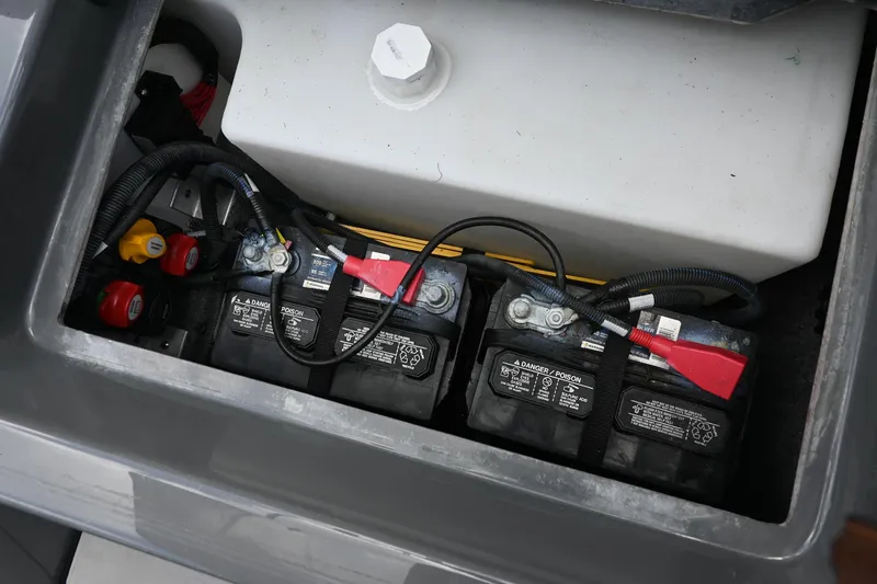 Slide: The Image of Battery compartment of 2021 Yamaha Boats 255XD, showing multiple connected batteries. - 29