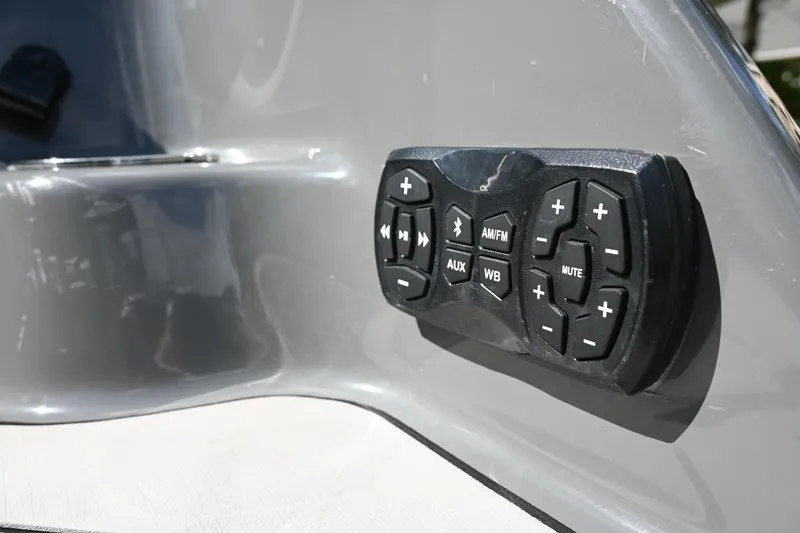 Slide: The Image of Yamaha Boats 255XD 2021 audio control panel on sleek gray surface. - 33