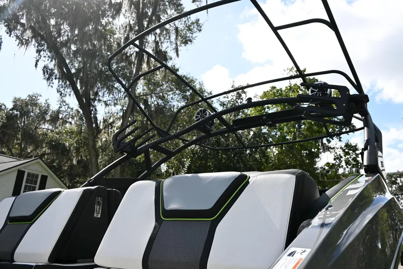 Slide: The Image of 2021 Yamaha Boats 255XD with sleek seating and modern design under a sunny sky. - 34