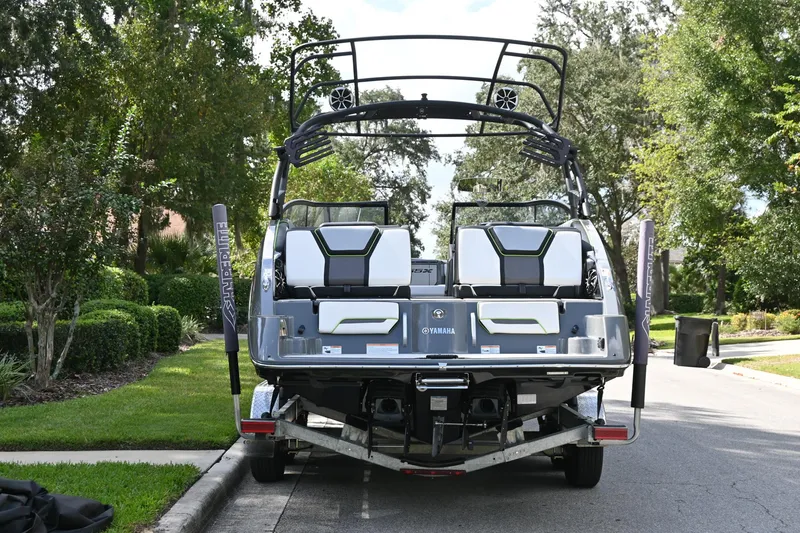 Slide: The Image of 2021 Yamaha Boats 255XD on trailer, parked on a suburban street. - 46