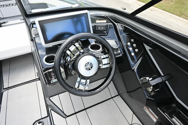 Slide: The Image of 2021 Yamaha Boats 255XD dashboard with steering wheel and touchscreen display. - 5