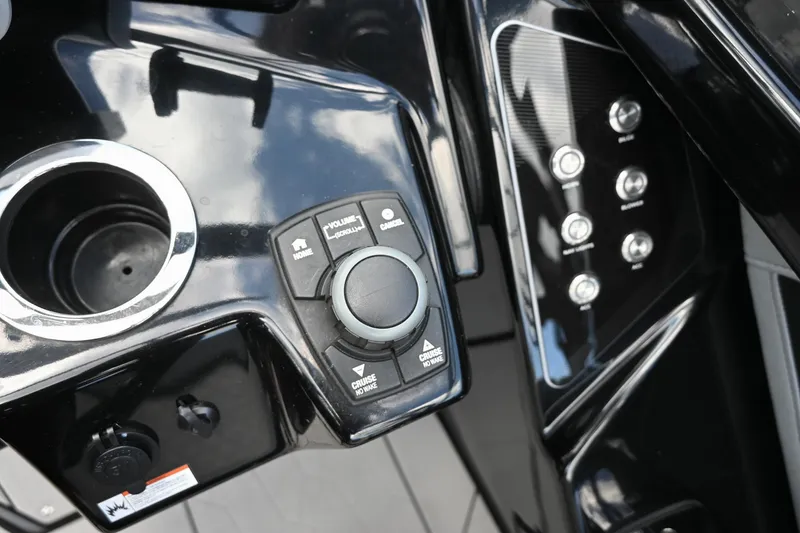 Slide: The Image of Control panel of 2021 Yamaha Boats 255XD with buttons and cup holder. - 9