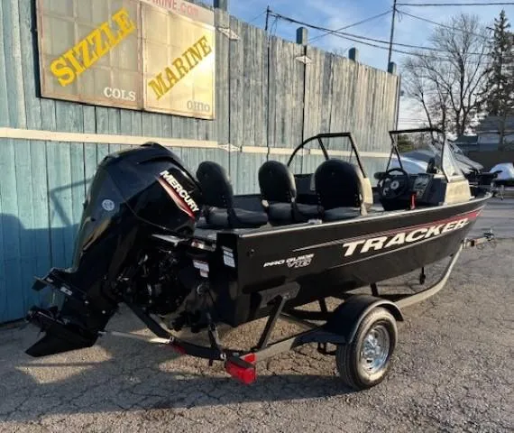 Slide: The Image of 2025 Tracker Pro Guide V-16 WT boat on trailer at Sizzle Marine dealership. - 2