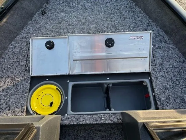 Slide: The Image of 2025 Tracker Pro Guide V-16 WT boat interior with storage compartments and yellow bucket. - 7