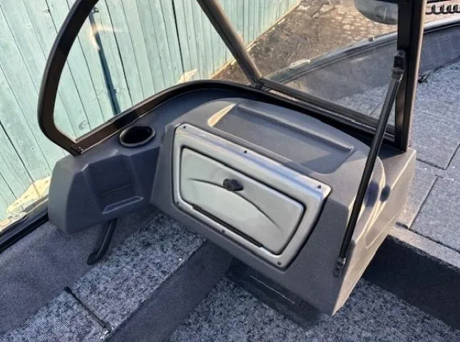 Slide: The Image of 2025 Tracker Pro Guide V-16 WT boat interior with windshield and storage compartment. - 9