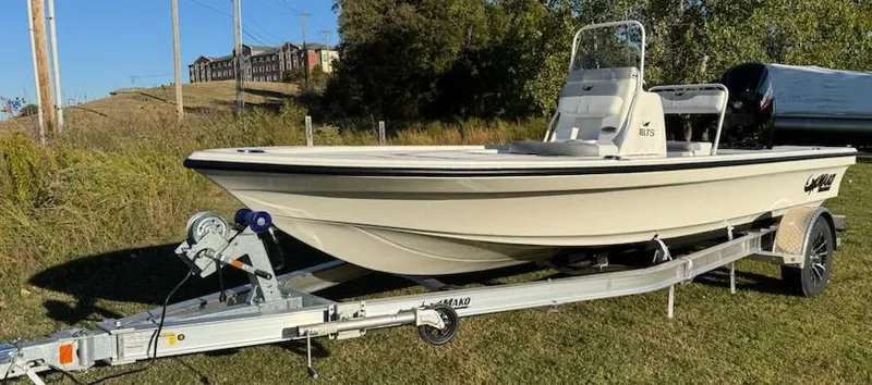 Slide: The Image of 2025 Mako 18 LTS boat on trailer, parked on grass. - 3