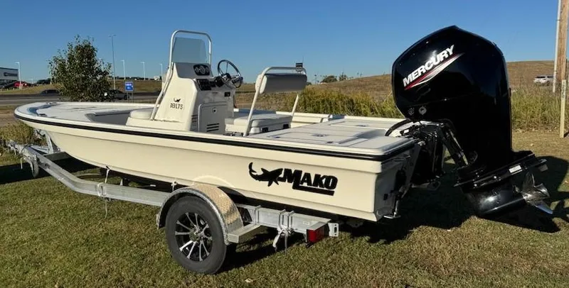 Slide: The Image of 2025 Mako 18 LTS boat with Mercury engine on trailer, parked on grass. - 5