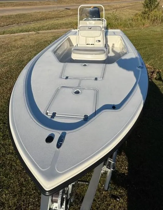 Slide: The Image of 2025 Mako 18 LTS boat on grass, showcasing sleek design and spacious deck. - 6