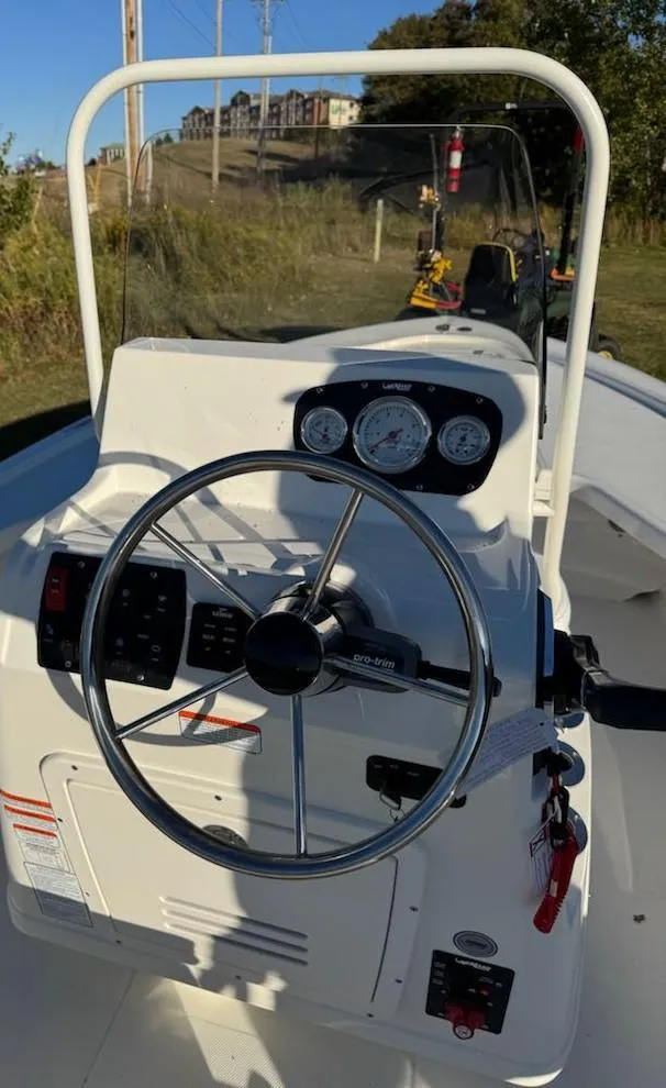 Slide: The Image of 2025 Mako 18 LTS boat dashboard with steering wheel and gauges. - 7