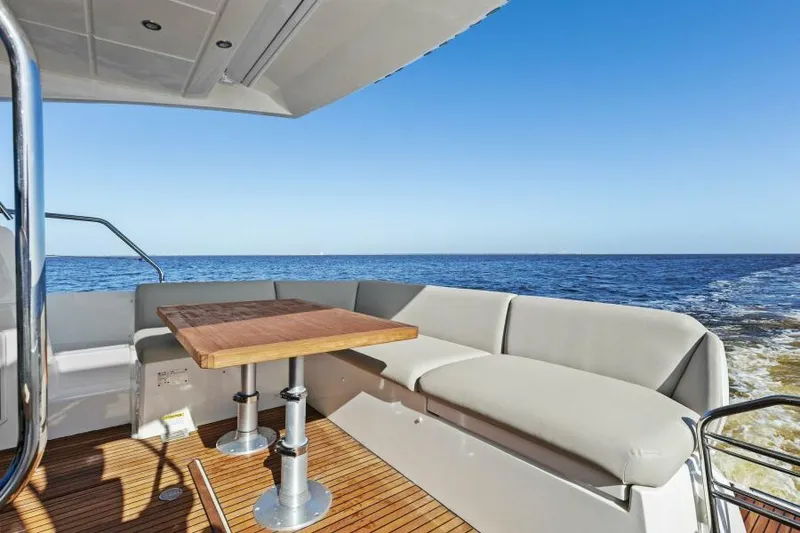 Slide: The Image of Prestige 460 yacht deck with seating and table, ocean view, 2022 model. - 10