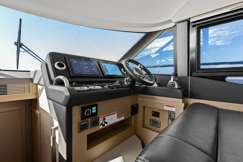 Slide: The Image of Prestige 460 yacht helm, 2022 model, featuring modern navigation controls and luxurious interior. - 24
