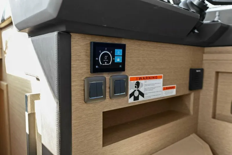 Slide: The Image of Control panel of a 2022 Prestige 460 yacht with warning label and switches. - 25