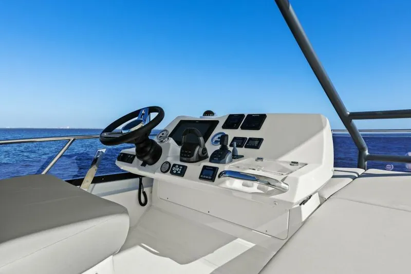 Slide: The Image of Prestige 460 yacht helm, 2022 model, with ocean view and clear blue sky. - 3