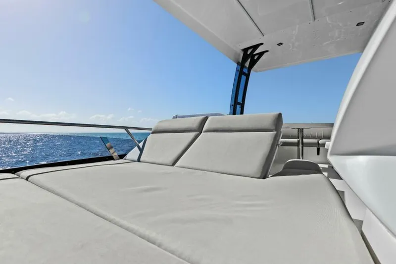 Slide: The Image of Prestige 460 yacht 2022, sun deck with ocean view, luxury relaxation. - 46