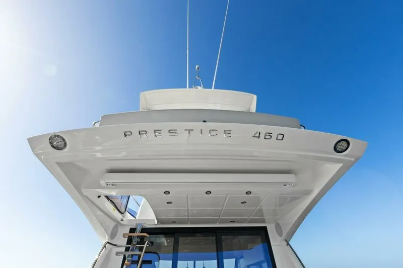 Slide: The Image of 2022 Prestige 460 yacht against clear blue sky, rear view. - 8
