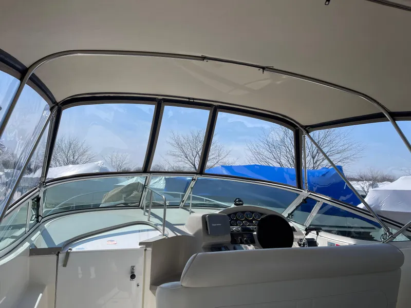 Slide: The Image of 2001 Cruisers Yachts 3075 Express cockpit with clear canopy and dashboard view. - 12
