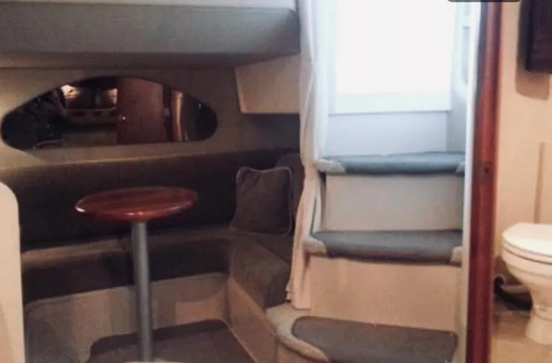 Slide: The Image of Interior of 2001 Cruisers Yachts 3075 Express, featuring seating area and steps. - 19