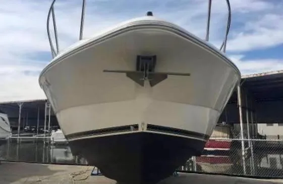 Slide: The Image of 2001 Cruisers Yachts 3075 Express boat, docked, front view. - 4