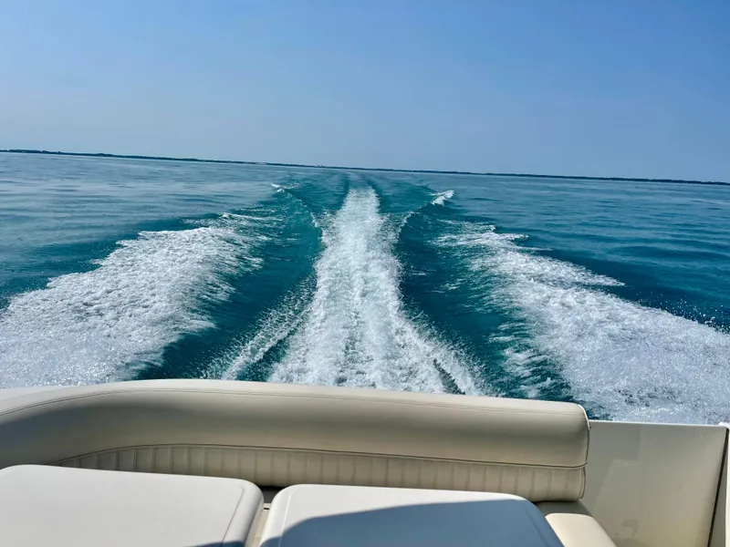 Slide: The Image of 2001 Cruisers Yachts 3075 Express cruising on open water, leaving a wake. - 9