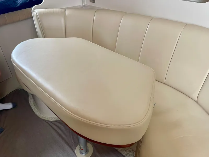 Slide: The Image of Cream leather seating and table inside 2001 Cruisers Yachts 3075 Express. - 15