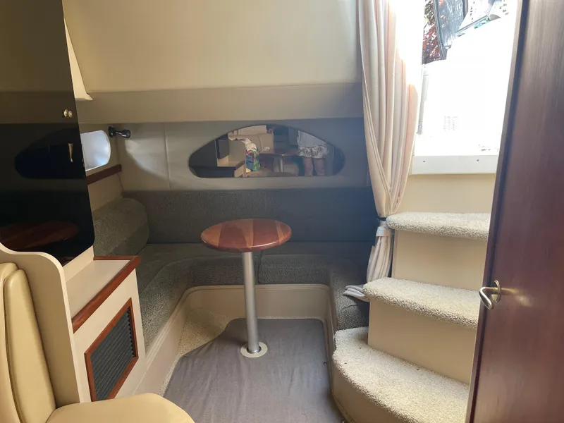 Slide: The Image of Interior of 2001 Cruisers Yachts 3075 Express with seating and table. - 18