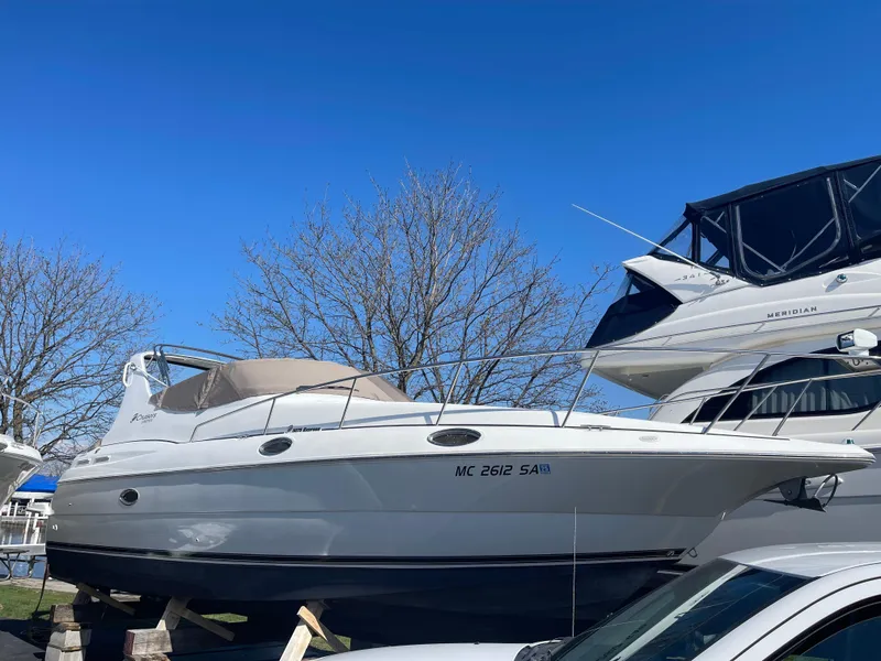 Slide: The Image of 2001 Cruisers Yachts 3075 Express boat on display under clear blue sky. - 2