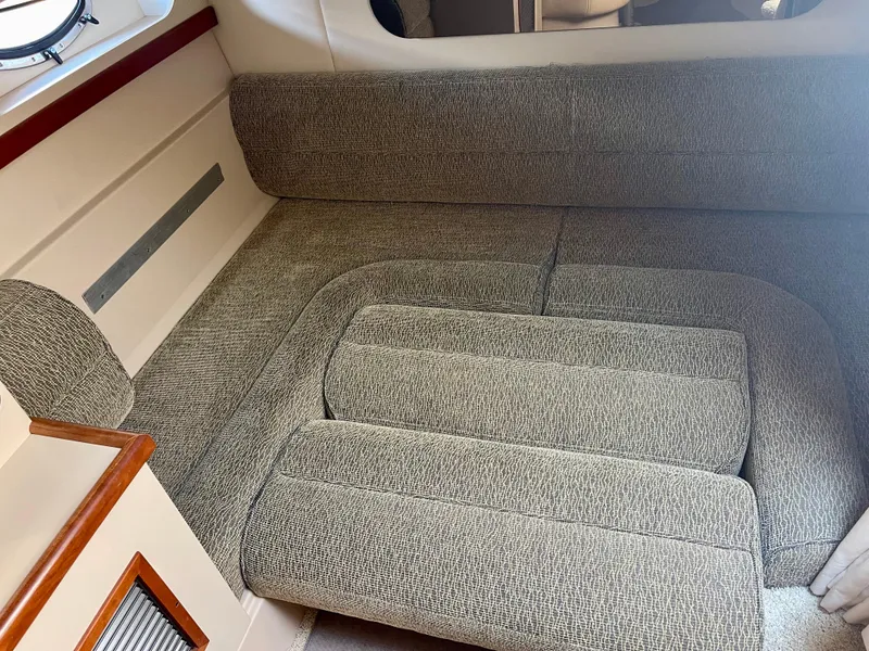 Slide: The Image of 2001 Cruisers Yachts 3075 Express interior seating with gray upholstery. - 21