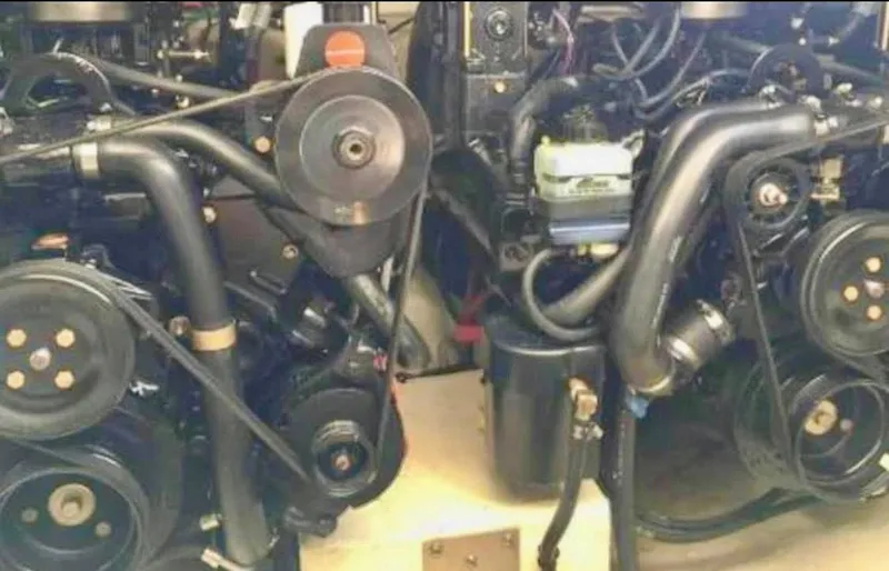 Slide: The Image of Engine compartment of 2001 Cruisers Yachts 3075 Express, showcasing dual engines and components. - 26