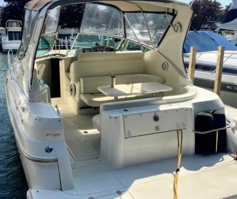 Slide: The Image of 2001 Cruisers Yachts 3075 Express, spacious deck, docked at marina. - 8