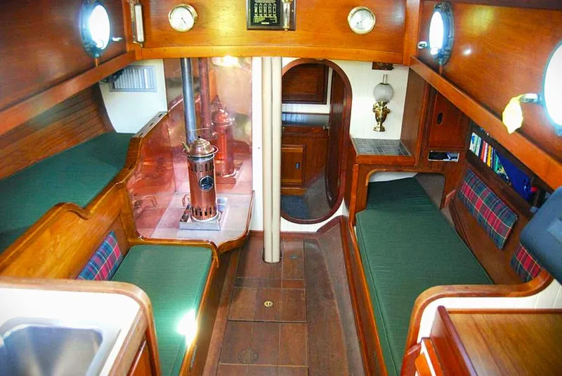 Slide: The Image of Interior of 1985 Bristol Channel Cutter, featuring wood paneling and cozy seating. - 2