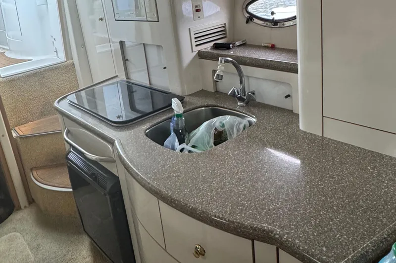 Slide: The Image of Maxum 3000 SCR 2000 boat interior kitchen with sink and countertop. - 10