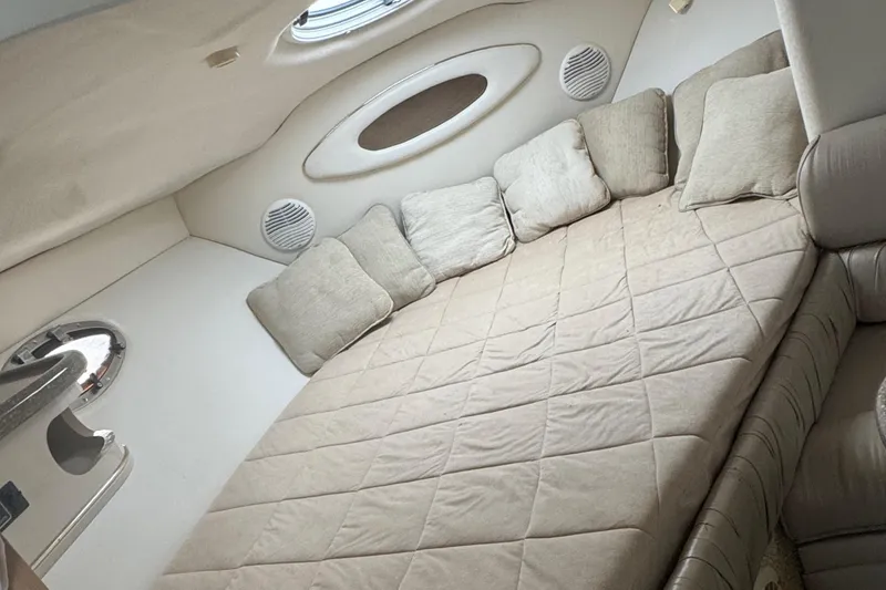Slide: The Image of Interior cabin of 2000 Maxum 3000 SCR boat with beige bedding and cushions. - 11