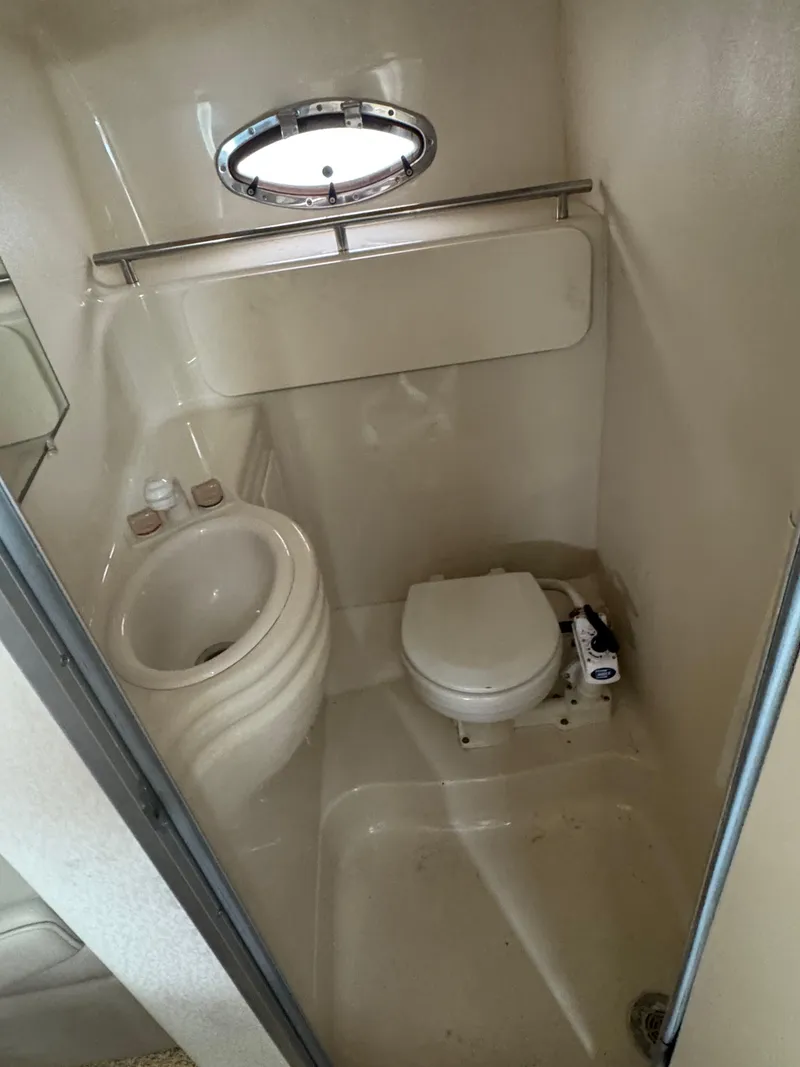 Slide: The Image of Compact bathroom in 2000 Maxum 3000 SCR boat with toilet and sink. - 7