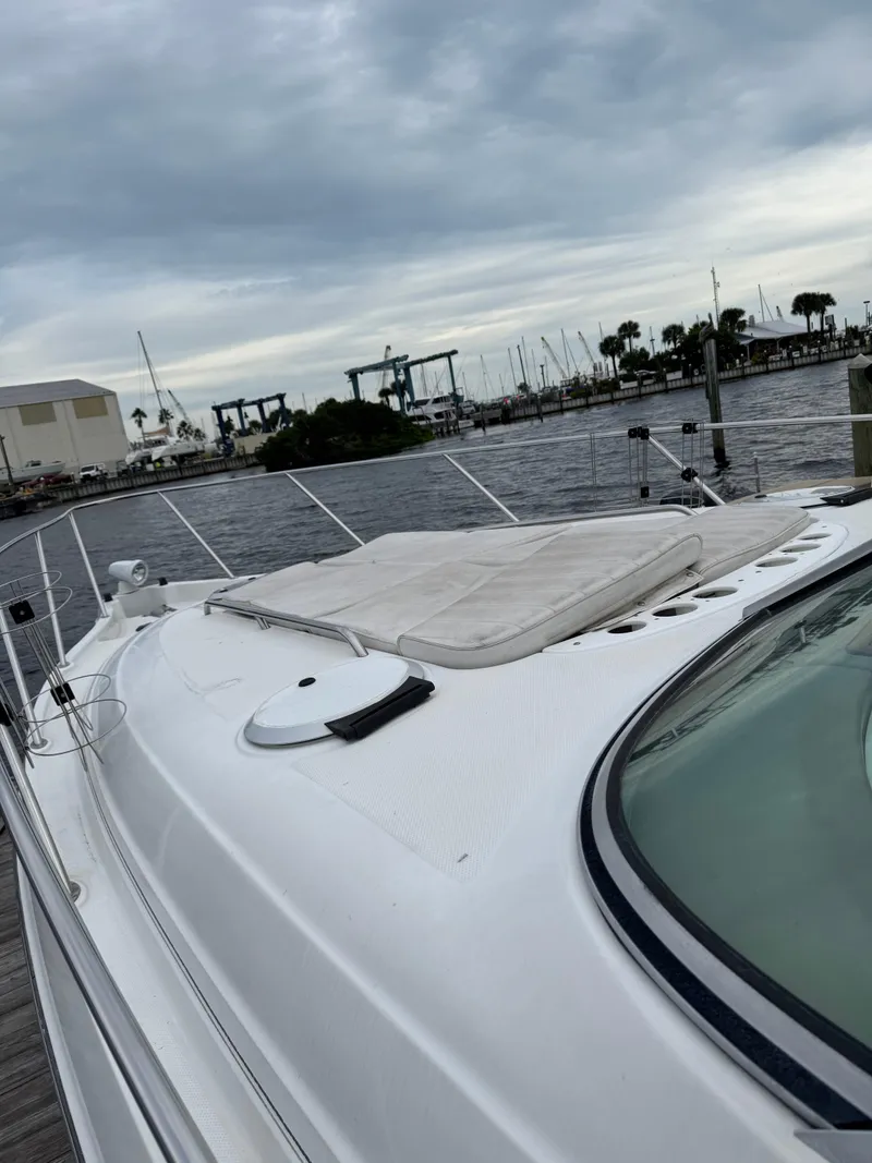 Slide: The Image of 2000 Maxum 3000 SCR yacht docked at marina under cloudy sky. - 8