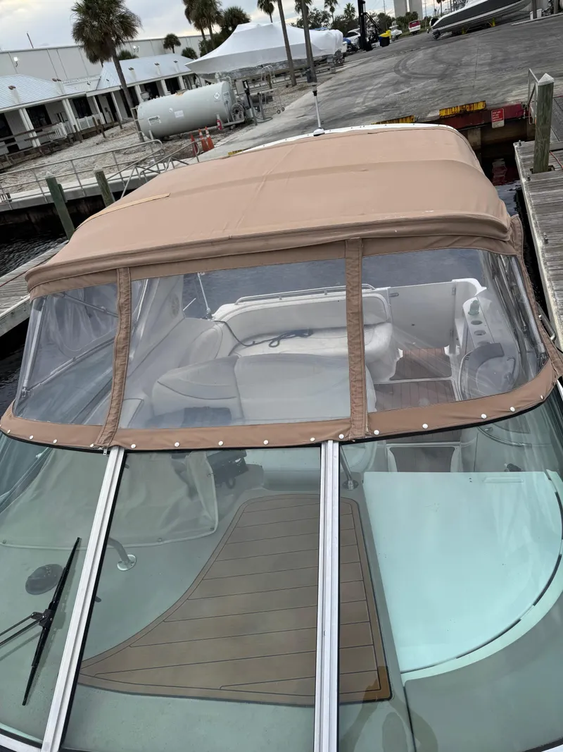 Slide: The Image of 2000 Maxum 3000 SCR boat with tan canopy docked at marina. - 9